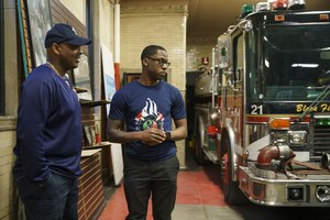 Chicago Fire Department Lt. Quention Curtis speaks with former student Ian Price at the Black Fire Brigade in the Washington Park neighborhood on April 7 in Chicago.