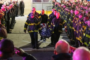 FDNY members salute as the body of Firefighter Timothy Klein is removed from Brookdale Hospital in Brooklyn on Sunday.