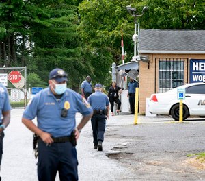 The Edna Mahan Correctional Facility's front gate and guardhouse as guards stand outside. Wednesday, August 4, 2021.