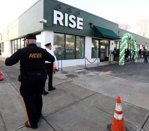 Police provide security outside RISE Medical Marijuana Dispensary on the first day of recreational marijuana sales in Bloomfield, N.J.