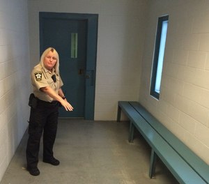 Assistant jail director Vicky White in 2016 shows a holding cell for inmates awaiting transfer.