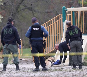 A K-9 officer is given the scent from a clue found during the Gloucester County Child Abduction Response Team drill Tuesday, April 26, 2022.