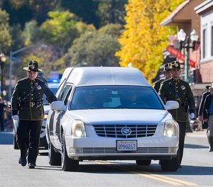 The honor guard walks with the hearse for fallen El Dorado County Sheriff s Deputy Brian Ishmael during his funeral procession in downtown Placerville on Tuesday, Nov. 5, 2019.