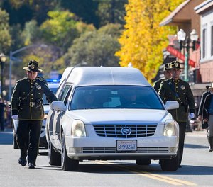 The honor guard walks with the hearse for fallen El Dorado County Sheriff s Deputy Brian Ishmael during his funeral procession in downtown Placerville on Tuesday, Nov. 5, 2019.