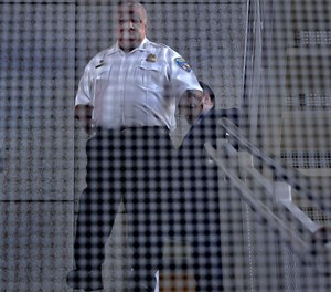 Michael Harrison, Baltimore Police commissioner, walks down the stairs of police headquarters to address the media on Wednesday., May 18, 2022.