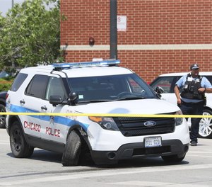 A Chicago Police Department SUV, smashed on both sides and with additional damages, faces east on West Harrison Street after being involved in a crash on June 13, 2022 in Chicago.