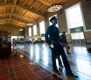 An LAPD officer patrols Union Station Tuesday, June 28, 2022. LA Metro is working on contracts with vendors to begin a first-ever program: LA Metro Ambassadors, an unarmed patrol team equipped with radios to call in homeless social workers or other support teams.