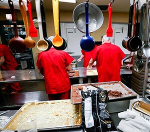 Inmates prepare meals in the kitchen at the Madison County Detention Center in Richmond, Kentucky.
