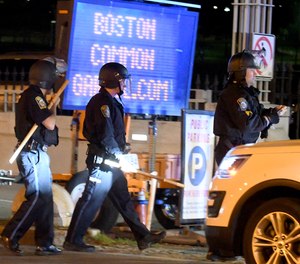 Police prepare to move out on Charles Gate near the Boston Common garage, Sunday May 31, 2020, in Boston.
