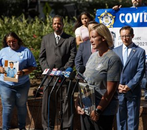 Julie Troglia talks with members of the media during a news conference outside City Hall before a City Council meeting on July 20, 2022, in Chicago. Troglia's husband, Jeff Troglia, 38, was a Chicago police officer who died by suicide in 2021.
