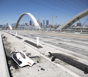 Car debris from a takeover crash remains on the 6th Street Viaduct on Tuesday, July 19, 2022 in Los Angeles, CA.