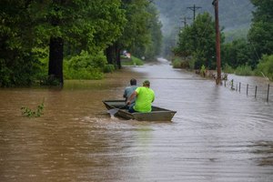 Men rode in a boat along flooded Wolverine Road in Breathitt County, Ky., on Thursday.