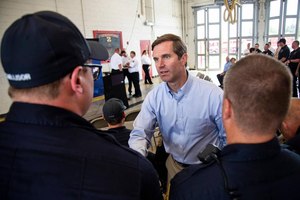 Kentucky Gov. Andy Beshear meets with members of the Lexington Fire Department, including the swift water rescue crew and ambulance units after they responded to the flooding in Eastern Kentucky.