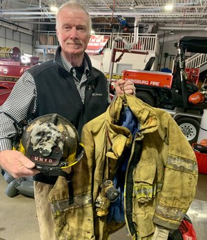 Twinsburg, Ohio, Firefighter Paul Nees with what remains of his turnout gear after experiencing a flashover while battling a house fire.
