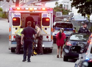 A man is rushed to a Boston EMS ambulance after a receiving a serious stab wound to the torso on June 19 in Boston. The EMS union said City Hall's pay offer is “considerably less than what the City agreed to with every other Union that has signed.”