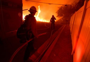 Firefighters helped keep the Fairview Fire, burning near Hemet, California, under 20,000 acres overnight after the fire more than tripled in size Wednesday.