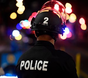 Denver police officers stand outside of McGregor Square as fans celebrate after the Colorado Avalanche wins the Stanley Cup Finals on June 26, 2022. City leaders want to spend a record amount of money in 2023 on police, fire and jail services.