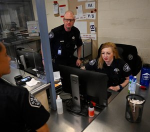 Denver sheriff's deputies work in processing as inmates come into Denver City Jail in downtown Denver on Oct. 13, 2022.