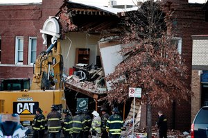 Kansas City firefighters on the scene in Westport after a fire truck collided with a car killing two people and causing a partial building collapse.