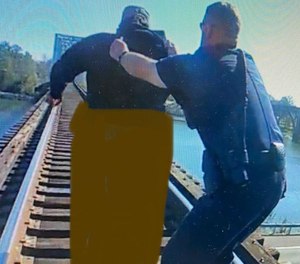 Three Gadsden police officers arrived on the scene at Railroad Bridge Friday, Nov. 18, within 90 seconds of being dispatched to find the person's vehicle disabled/stuck on the bridge and that person already over the traffic lanes of Albert Rains Boulevard.