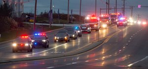 A procession travels along Route 100 on Thursday with the remains of two New Tripoli firefighters who died Wednesday after battling a house fire in West Penn Township, Schuylkill County.