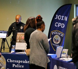 Candidates talk with various law enforcement agencies during a hiring expo March 28, 2022. The Virginia Beach and Chesapeake police departments are among those gearing up to offer incoming transfers a condensed training course in 2023 following Gov. Glenn Youngkin s October announcement of a nationwide law enforcement recruitment campaign.