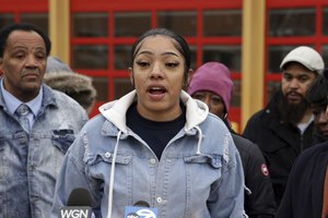 Lauren Lashley (center) calls for broader access to the Chicago Fire Department entrance exam during a press conference in the 1700 block of West 95th Street in Chicago on Monday. 