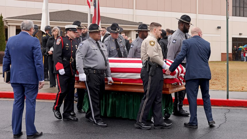 The honor guard carries the casket of Scott Riner during the funeral at North Metro Church, Tuesday, December 20, 2022.
