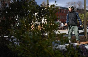 Ebram Victoria, of 2nd Nature Design and Landscape through Arts and Parks, waters plants in the memorial park project to honor Lt. Paul Butrim, Lt. Kelsey Sadler and firefighter-EMT Kenny Lacayo, who died when a vacant home collapsed on Jan. 24, 2022. Victoria designed the memorial at 205 S. Stricker St., the site of the collapse.