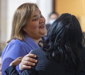 City Councilmember Eunisses Hernandez, right, greets colleagues at LA City Council meeting on Tuesday, Dec. 13, 2022 in Los Angeles, CA.