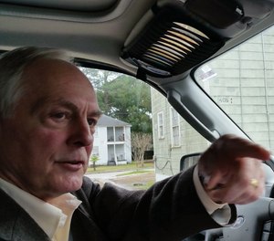 Mark Johnson drives through one of the neighborhoods he once patrolled as a member of the Mobile Police Department.