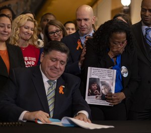 Gov. J.B. Pritzker signs comprehensive legislation to ban military-style firearms on Jan. 10, 2023.
