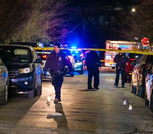 NYPD officers and detectives search for evidence as they investigate the shooting of an off-duty police officer on Ruby Street, Saturday evening.