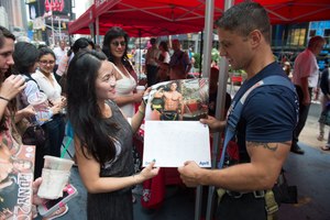 Stephanie Wong of Queens talked with Firefighter Ralph Ciccarelli in Times Square, where the 2014 Calendar of Heroes firefighter models were on hand to sign autographs for fans on July 23, 2013.