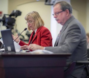 Vicki Reed, left, Kentucky Department of Juvenile Justice commissioner, and John Hicks, executive cabinet secretary and state budget director, present at a subcommittee meeting.