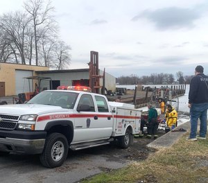 Brewerton firefighters load an airboat on to a truck after escorting two ice fisherman off the ice on Wednesday, Feb. 16, 2023.