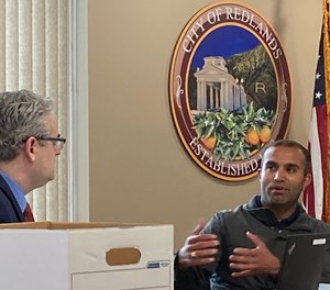 Redlands Police Officer Lalit Bali (right) testifies at his arbitration hearing at Redlands City Hall.