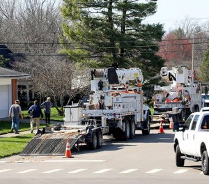 Trucks with the Public Service Company of Oklahoma sit on Jesselin Drive Monday, March 6, 2023, in Lexington, Ky. The crews were making repairs and putting up new electric poles after a strong wind storm knocked out power to much of Lexington three days earlier.