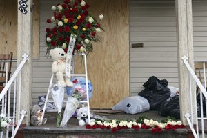 A memorial of teddy bears, a balloon, bouquets and a flower wreath have been on the front porch of Chicago Firefighter Walter Stewart's home.