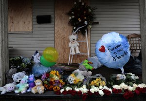 Stuffed animals adorn the front porch of Chicago Firefighter Walter Stewart's home, where a fire claimed the lives of his wife and three children.