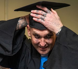 Graduating inmate Richard Teer, 46, in cap and gown ready for Offender Mentor Certification Program graduation ceremony at California State Prison.