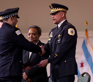 Mayor Lori Lightfoot and First Deputy Superintendent Eric Carter congratulate new officers during a Chicago Police Department graduation ceremony at Navy Pier on March 7.