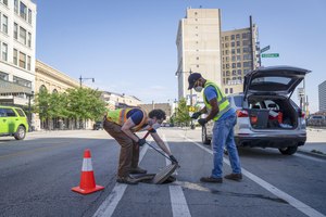 Evan Berkowitz (left) with Infrastructure Engineering and John Leavell of Current Water tested wastewater for the presence of coronavirus variants on Chicago's Northwest Side on July 21, 2022. The polio virus also can be detected in wastewater.