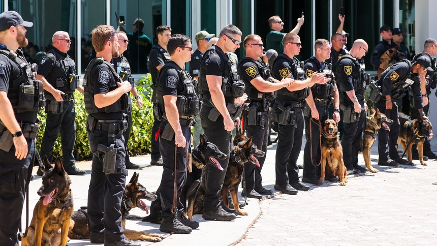 Members of the K-9 teams of the Pinellas County Sheriff’s Office and Largo Police Department look on as sheriff's Cpl. Matt Aitken is discharged from Bayfront Health St. Petersburg on Friday.