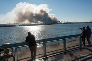 Bystanders watched as a massive fire engulfed an NYPD warehouse on Columbia St. in Brooklyn on Dec. 13.