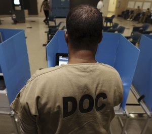 A detainee votes at an early voting polling place inside Division 11 of the Cook County Jail, March 25, 2023, in Chicago.