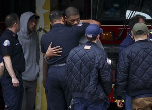 Firefighters hugged Wednesday at the Chicago Fire Department station that houses Tower Ladder 10.