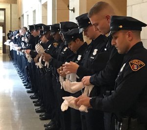 Members of the 142nd Cleveland Police Academy class prepare for their graduation ceremony at City Hall Friday, Feb. 8.