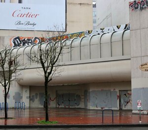 A man cycles past the vacant Washington Center complex near the corner of Southwest Fourth Avenue and Washington Street on Monday, April 10, 2023.