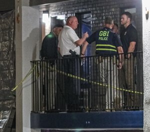 The wounded officer was taken to a hospital.